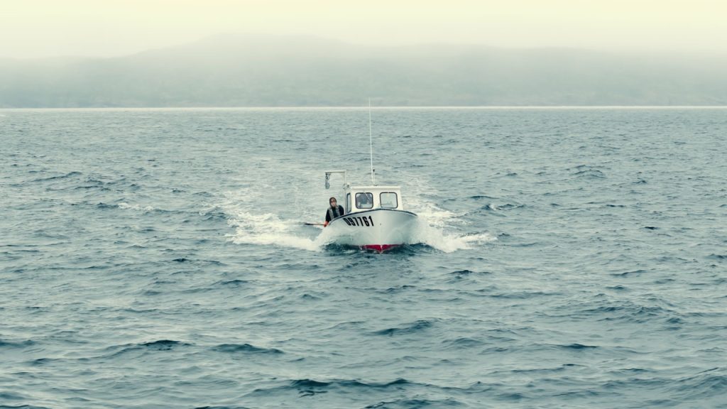 We captured the vast expanse of the North Atlantic in this breathtaking aerial shot of the Warford family's fishing boat navigating the grey seas of Newfoundland. Filmed by a drone, the misty fog blankets the coastline in the distance, adding an aura of mystery and intrigue to the scene. Against this atmospheric backdrop, the Warford family braves the elements, their small fishing boat a symbol of resilience and determination in the face of nature's challenges. Join us in admiring the beauty and tranquility of Newfoundland's coastal waters, where tradition and adventure converge.
